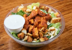 Buffalo chicken salad tossed with romaine, ranch, pepper jack cheese, and croutons.