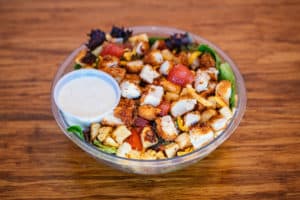 Chicken Club Salad with Breaded chicken, bacon, egg, mixed greens, tomato, cheddar jack & croutons.  Served w/ranch