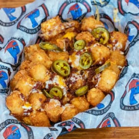 Loaded tater tots with cheddar jack cheese, bacon, and jalapenos