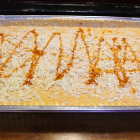 Buffalo Chicken Dip Appetizer catering tray blended with ranch and sour cream. Served with pita points and tortilla chips
