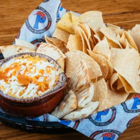 Delicious 3 cheese Buffalo Chicken Dip Appetizer with warm pita points and tortilla chips