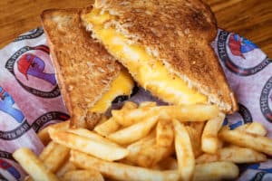 Crispy grilled cheese sandwich with fries