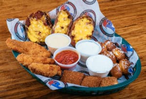 Delicious appetizer combo platter consisting of Potato skins, pretzel bites, toasted ravioli, and chicken fingers.  Served w/Sour cream, ranch, beer cheese, & marinara
